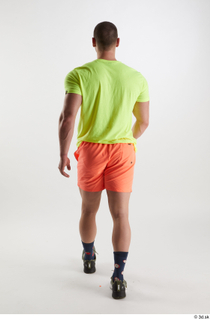 Joel  1 back view dressed green sneakers orange shorts…